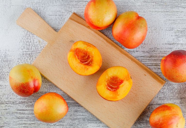 nectarines-grungy-cutting-board-table-flat-lay_176474-8663.jpg