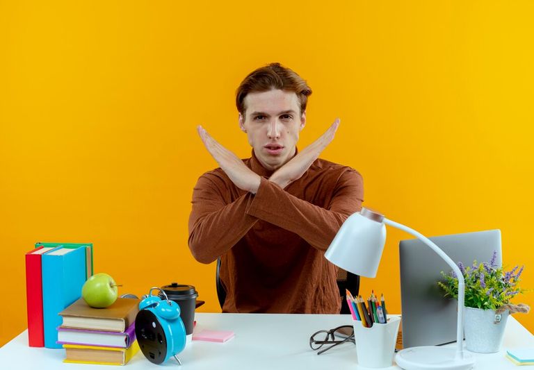 young-student-boy-sitting-desk-with-school-tools-showing-gesture-no_141793-81218.jpg