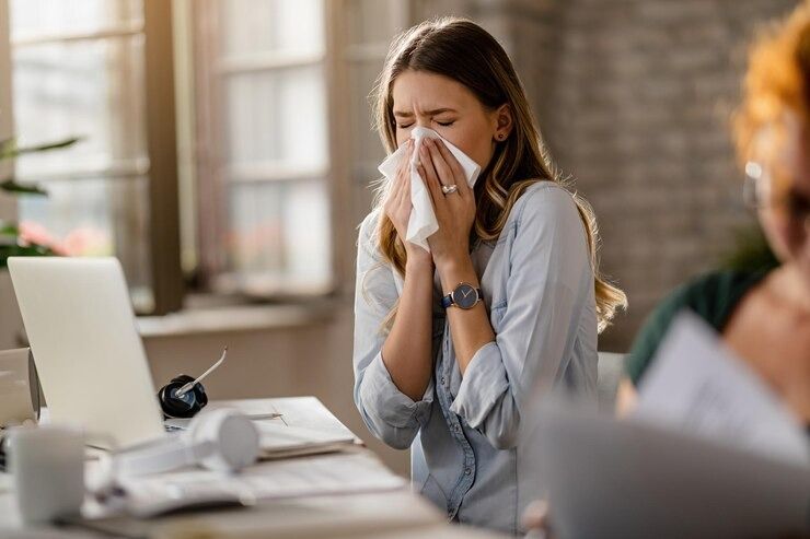 young-sick-businesswoman-sneezin.jpg