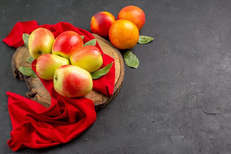 front-view-fresh-apples-with-peaches-dark-table-color-fresh-ripe-fruit-tree_140725-124612.jpg