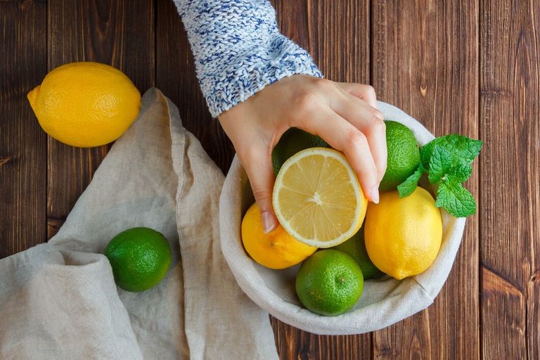 set-white-cloth-hands-holding-lemon-lemons-basket-wooden-surface-top-view_176474-14112.jpg