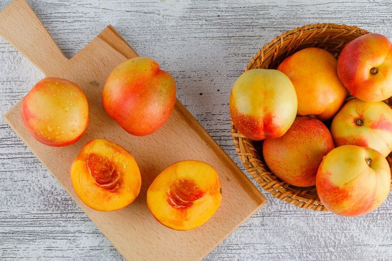 nectarines-basket-grungy-cutting-board-table-flat-lay_176474-8581.jpg