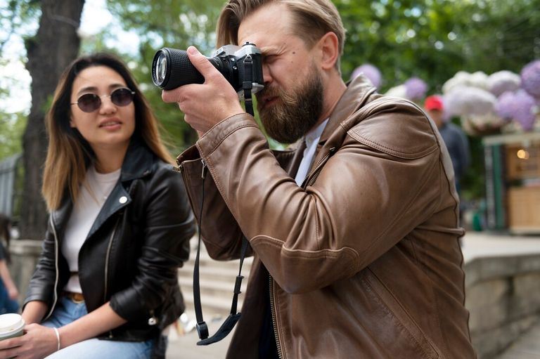 couple-synthetic-leather-jackets-using-photography-camera-outdoors_23-2149448453.jpg