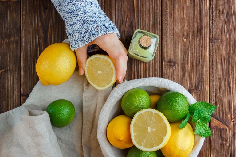 set-white-cloth-hands-holding-lemon-lemons-basket-wooden-surface-top-view_176474-14114.jpg