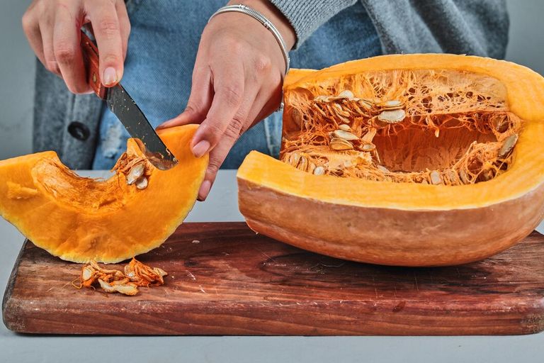 woman-hand-cutting-slice-pumpkon-with-knife-wooden-board_114579-62065.jpg