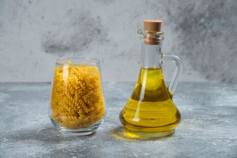 glass-bowl-with-raw-spiral-macaroni-with-bottle-oil_114579-38588.jpg