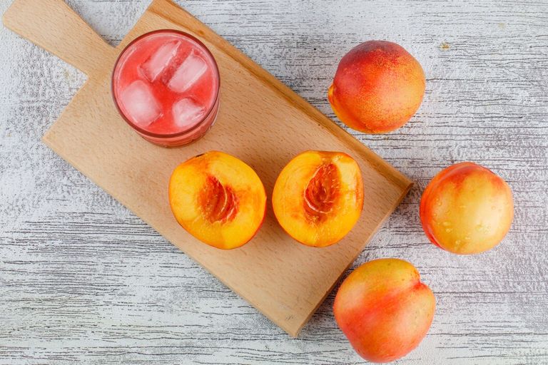 nectarines-with-juice-grungy-cutting-board-table-flat-lay_176474-8771.jpg