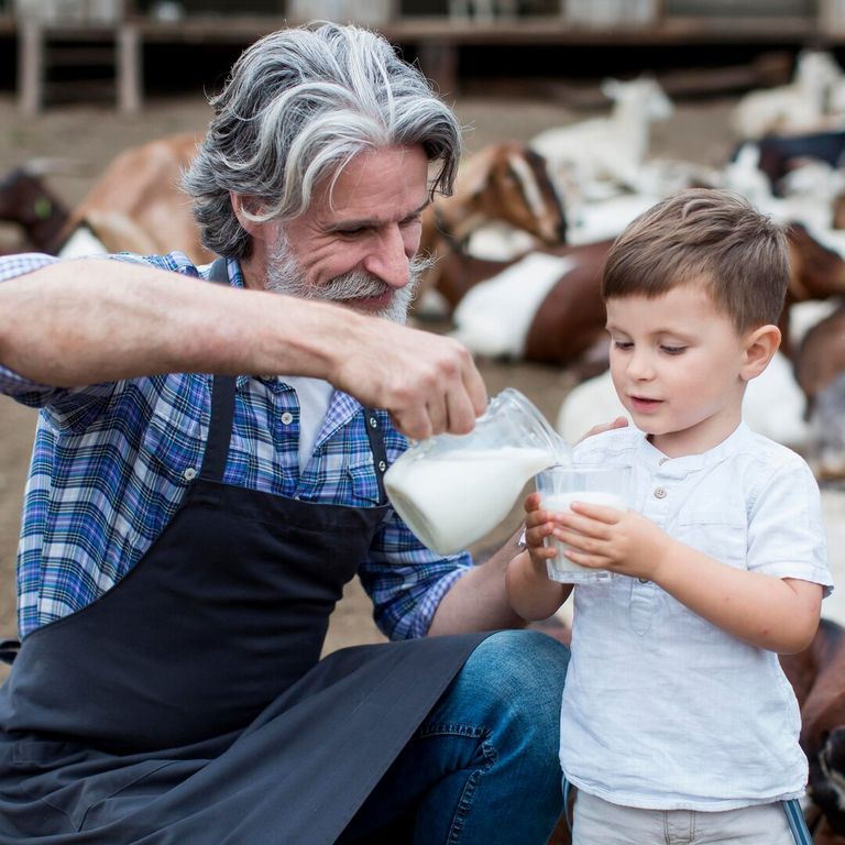 man-giving-boy-goat-milk_23-2148673060.jpg