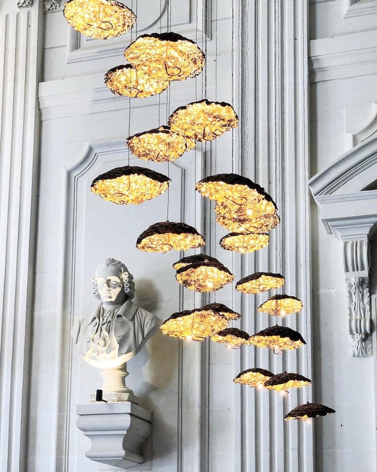 Stunning black and gold lighting illuminate this magnificent foyer