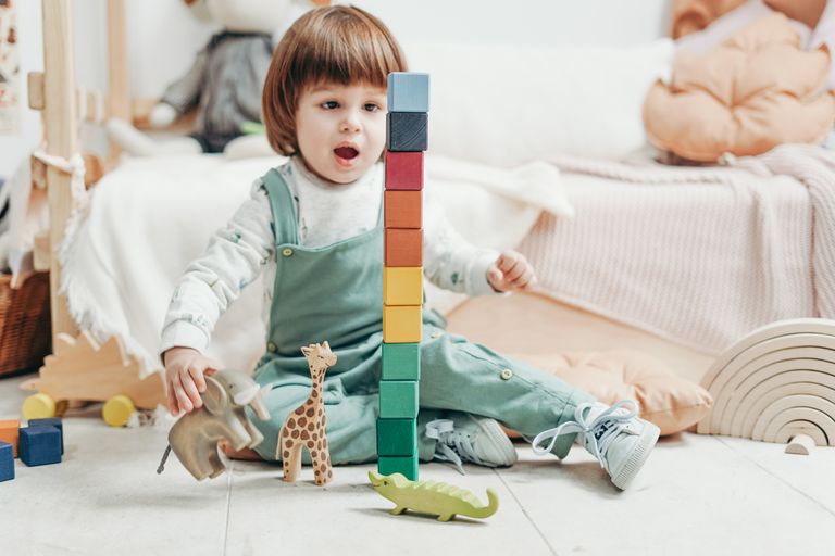 child-in-white-long-sleeve-top-and-green-dungaree-trousers-3661352.jpg