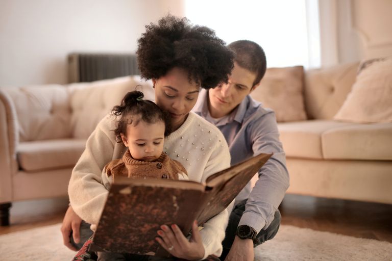 photo-of-woman-holding-brown-book-with-her-child-3818561.jpg