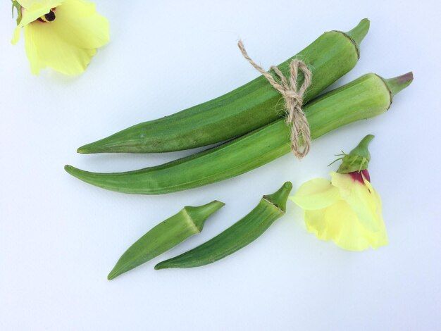 close-up-okras-with-yellow-flowers-white-table_1048944-1314874.jpg