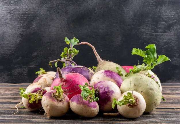 top-view-white-radishes-with-some-leaf-dark-wooden-table_176474-1515.webp