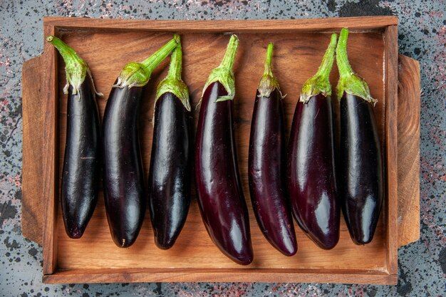 top-view-black-eggplants-inside-cutting-board-light-surface-food-color-ripe-meal-fresh-salad-vegetable-dinner_179666-19675.jpg