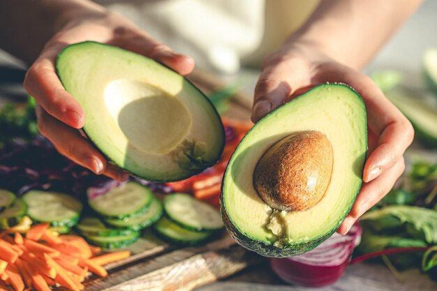 closeup-cut-avocado-womans-hands_169016-52141.jpg