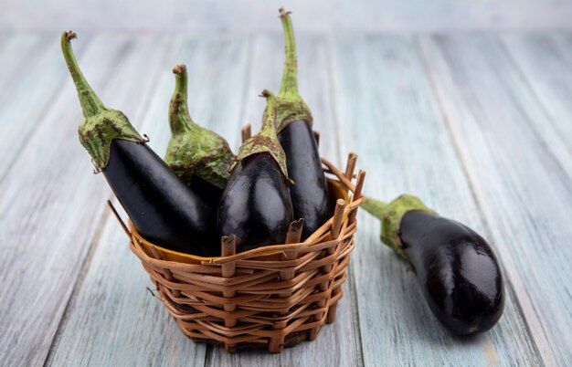 side-view-eggplants-basket-wooden-background_141793-49496.jpg