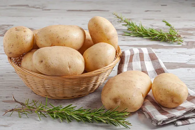 raw-potatoes-woven-wicker-basket-with-natural-rosemary-leaves-wooden-rustic-table_181624-47259.webp