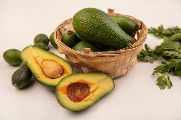 top-view-bright-fresh-avocados-bucket-with-feijoas-with-half-avocados-isolated-white-surface_141793-80748.jpg