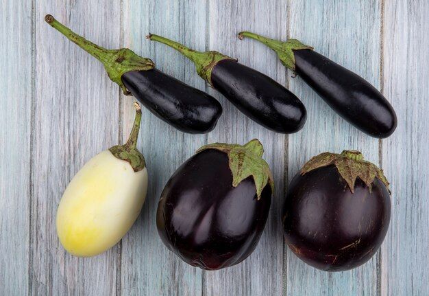 top-view-pattern-eggplants-wooden-background_141793-53175.jpg