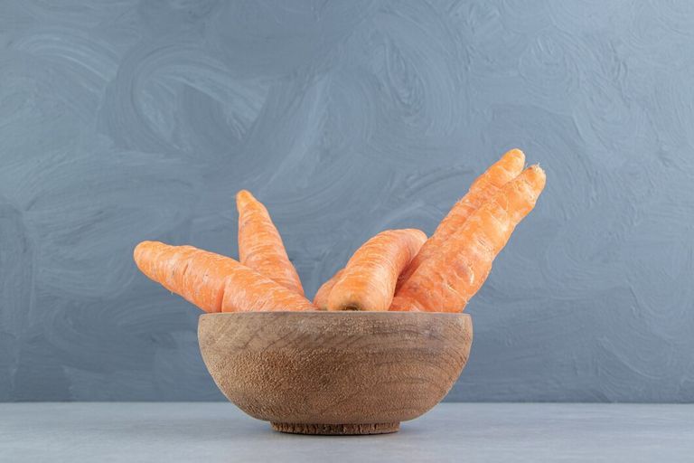 ripe-carrots-bowl-marble-background_114579-67014.jpg