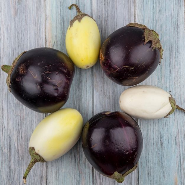 top-view-pattern-eggplants-wooden-background_141793-53174.jpg