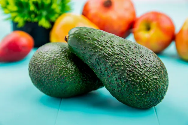 front-view-green-fresh-avocado-blue-surface_141793-13851.webp