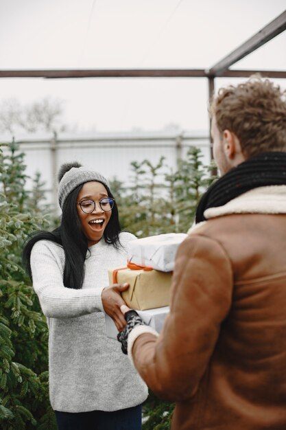 winter-concept-guy-brown-coat-salesman-christmas-tree-international-couple_1157-48619.jpg