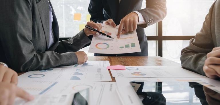 team-of-business-people-working-together-in-the-meeting-room-office-teamwork-background-charts-and-graphs-banner-double-exposure-successful-teamwork-business-planning-concept-photo.jpg