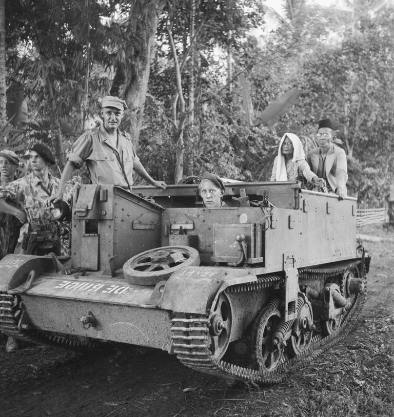 Dutch soldiers with old Indonesian couple, September 1947.jpg