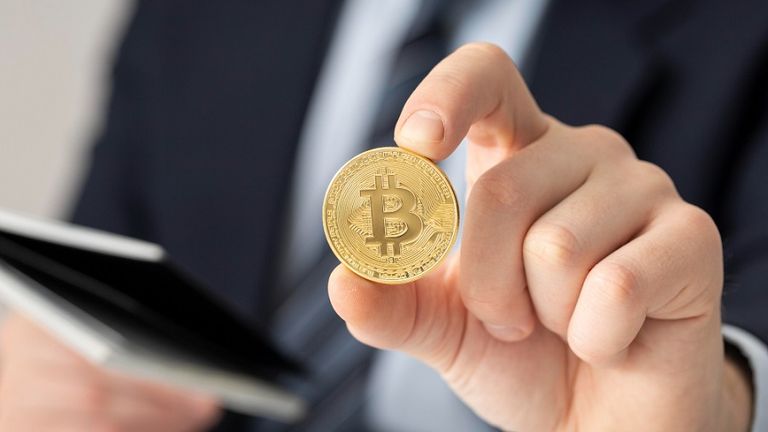 businessman-holding-bitcoin-close-up.jpg