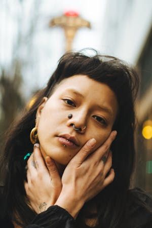 free-photo-of-portrait-of-a-brunette-woman-with-a-fringe-piercing-and-beauty-mark.jpeg