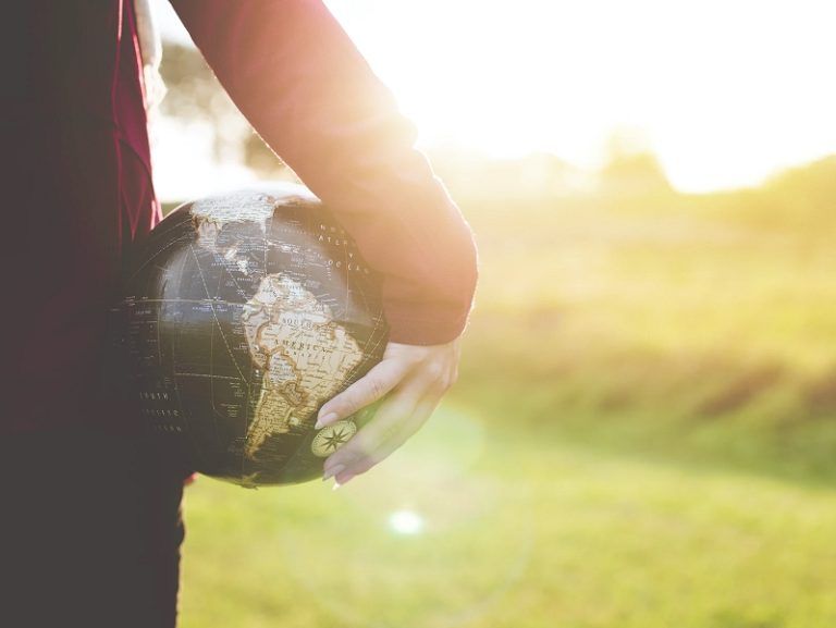 person-holding-globe-in-hand-768x577.jpg