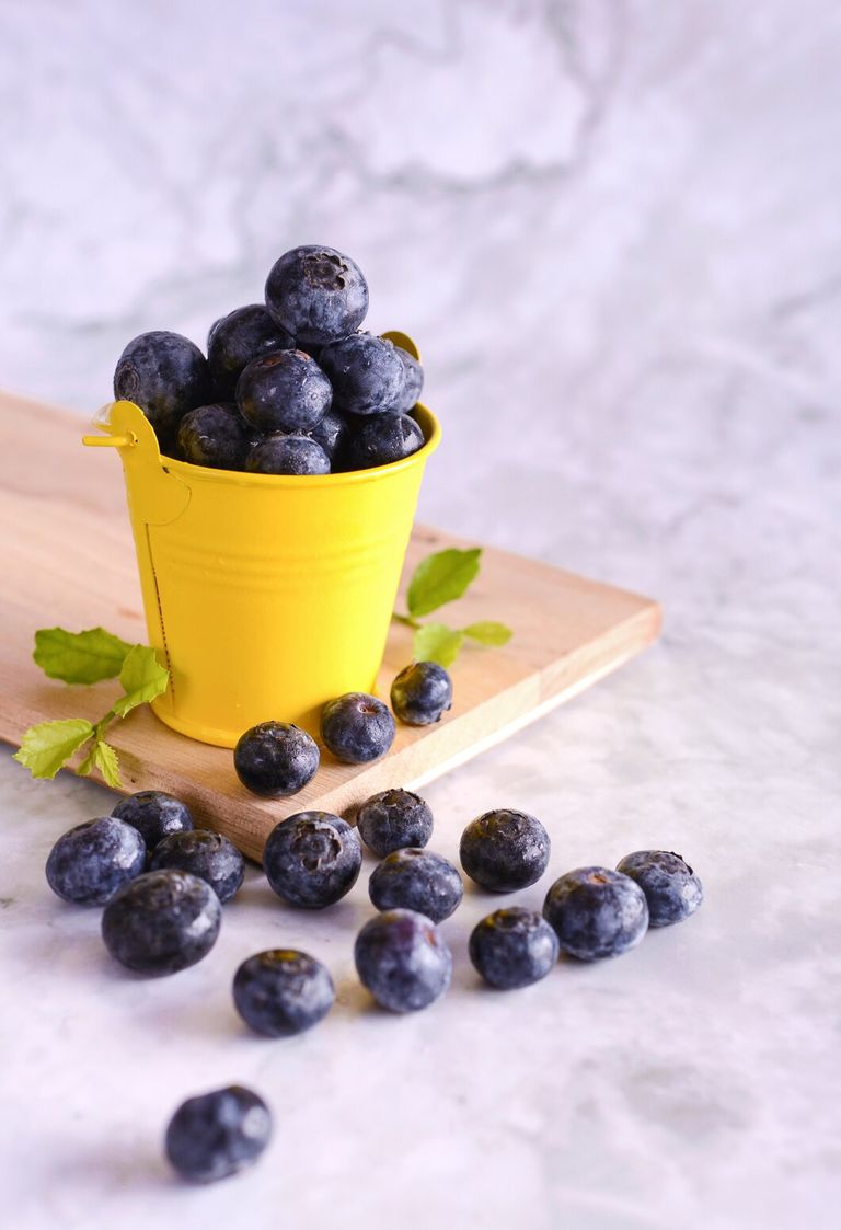 freshly-picked-blueberries-yellow-can_1150-18278.jpg