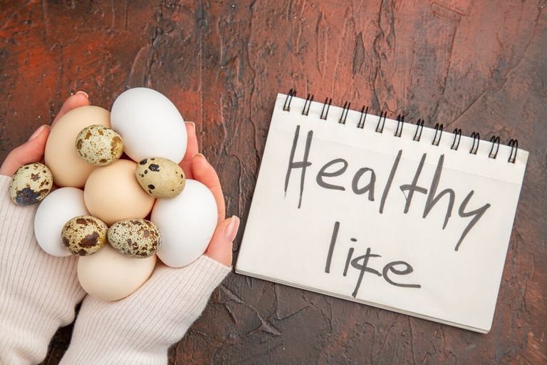 top-view-white-chicken-eggs-female-hands-dark-table_140725-137506.jpg