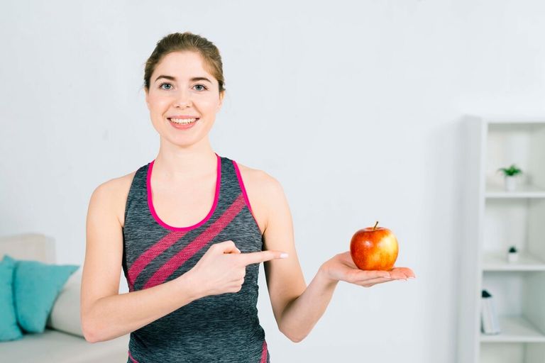 portrait-happy-young-fitness-woman-showing-red-apple-hand_23-2148047423.jpg