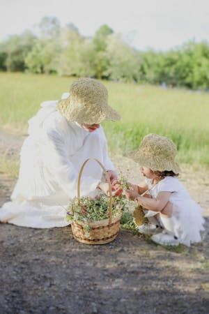free-photo-of-mother-and-daughter-in-white-dresses-and-hats-picking-flowers-on-a-meadow.jpeg
