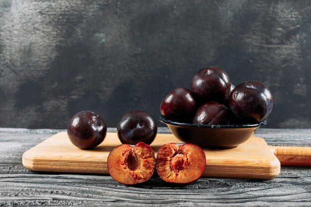 savory-plums-dish-wooden-board-white-wood-dark-grey-background-side-view_176474-4625.jpg