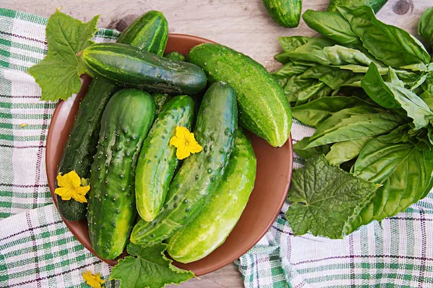 fresh-cucumbers-from-garden-table-summer-garden-top-view_2829-5821.webp