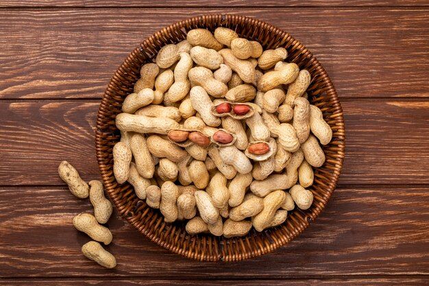 top-view-peanuts-shell-basket-wooden-table_141793-7393.jpg