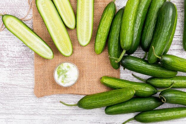 top-view-cucumber-sliced-with-white-yogurt-beige-linen-bag-white-wooden-horizontal_176474-1289.jpg