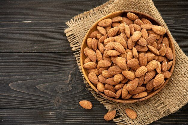 almond-wooden-bowl-wooden-background-near-bag-from-burlap-healthy-food-snack-organic-vegetarian-food_1150-37656.jpg