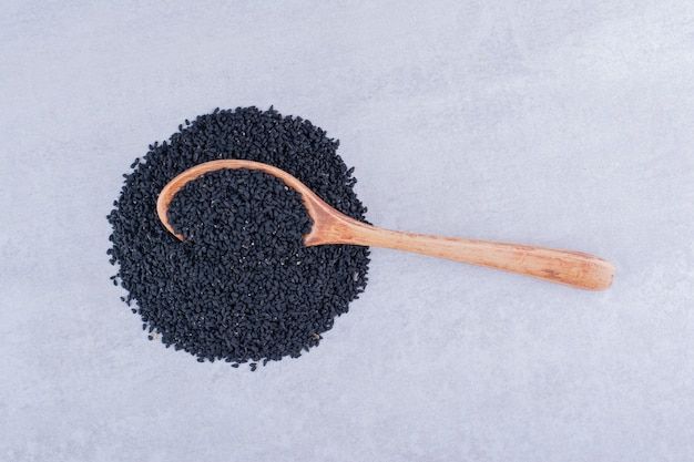 black-cumin-seeds-wooden-spoon-concrete-surface_114579-71093.jpg