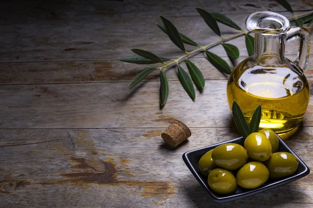 tasty-looking-olives-extra-virgin-olive-oil-olive-leafs-dark-wooden-background_181624-43771.webp