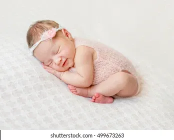 lovely-newborn-girl-sleeping-on-260nw-499673263.webp