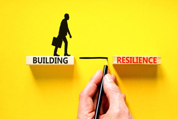 building-resilience-symbol-concept-word-building-resilience-typed-on-wooden-blocks-beautiful-yellow-table-yellow-background-businessman-hand-business-and-building-resilience-concept-copy-space-stockpack-adobe-stock-600x400.jpg