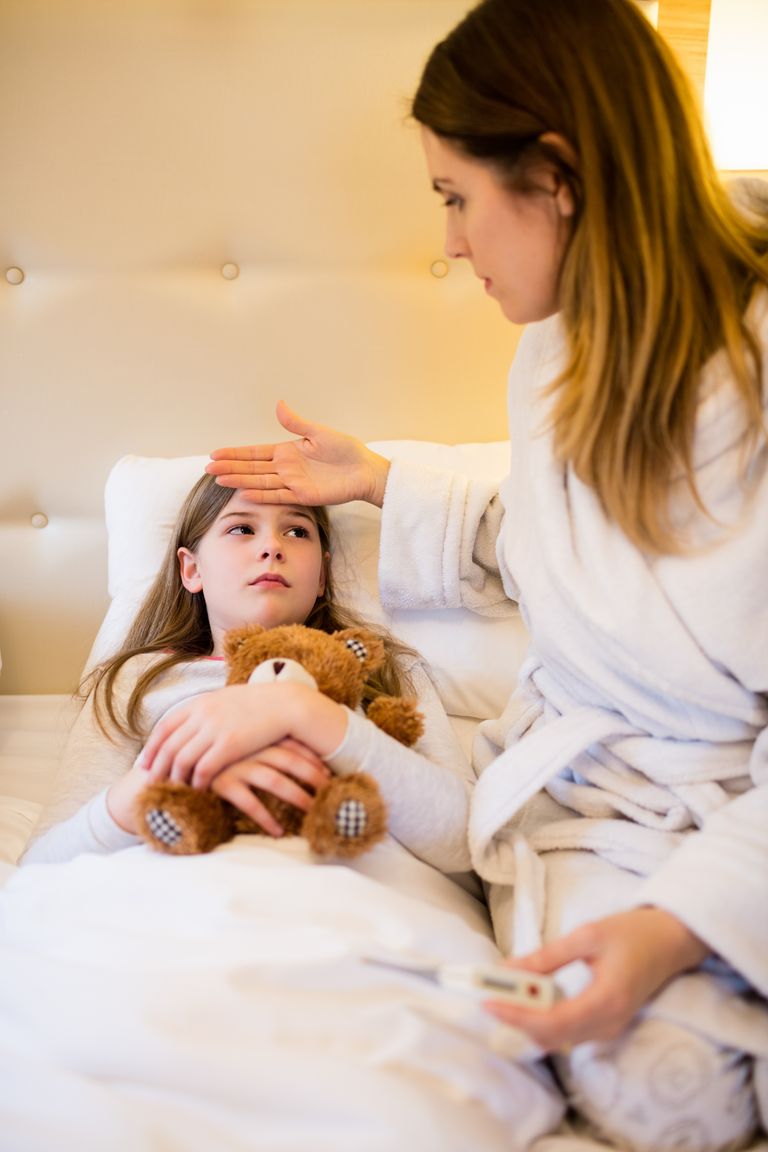 mother-checking-fever-her-daughter-bedroom.jpg