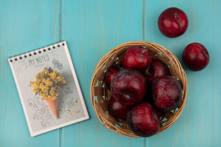 top-view-smooth-skinned-pluots-bucket-with-pluots-isolated-blue-wooden-wall_141793-76316.jpg