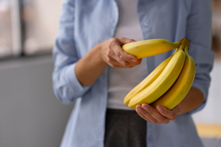 front-view-woman-holding-bananas_23-2150241090.jpg