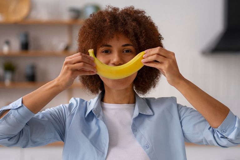 front-view-woman-holding-banana_23-2150241092.jpg