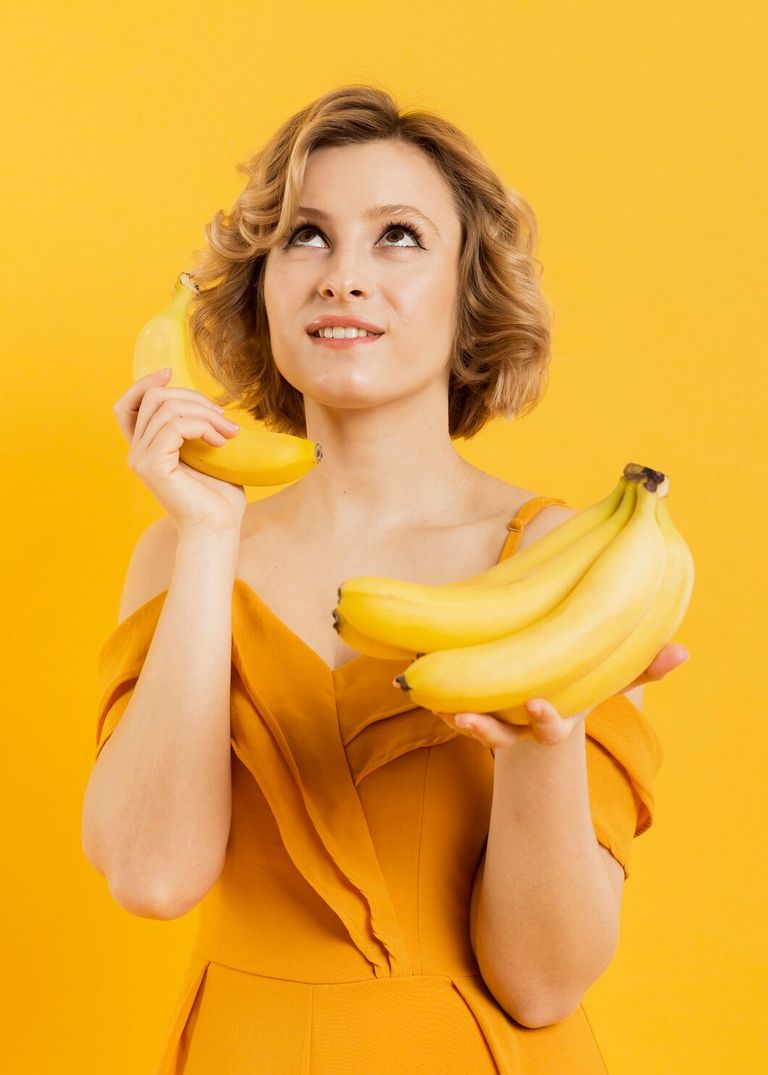 low-angle-woman-using-banana-as-mobile_23-2148450393.jpg